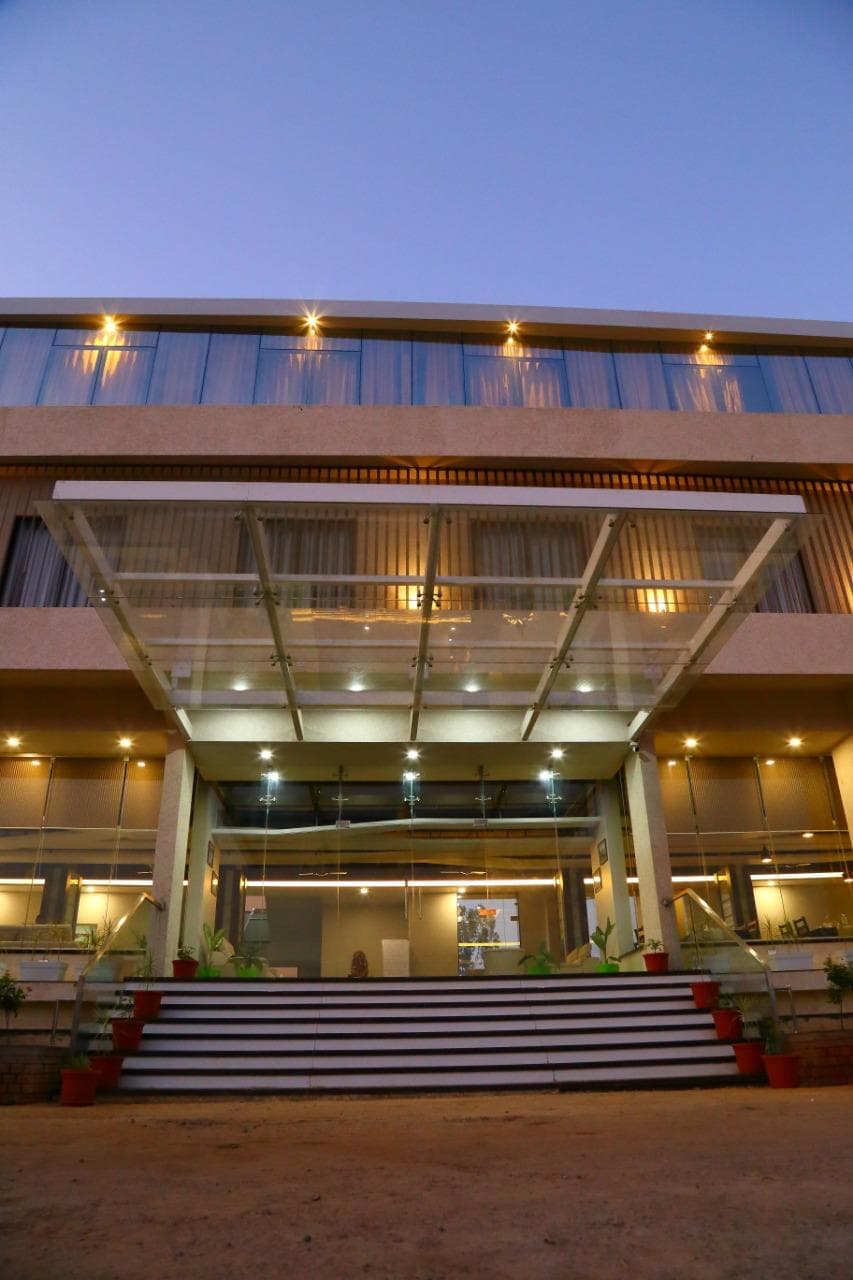 The lit entrance portico at Hotel Triveni